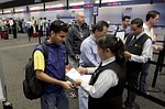 SAN FRANCISCO - AUGUST 11:  A United Airlines passenger has his identification checked at an empty security checkpoint at San Francisco International Airport August 11, 2006 in San Francisco. The Department of Homeland Security raised the terrorism alert to Red on Thursday, the highest level, for commercial flights from Britain to the United States because of an alleged terrorist plot on airline flights. The U.S. government banned all liquids and gels from flights effective immediately.  (Photo by Justin Sullivan/Getty Images)